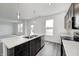 Bright kitchen featuring an island with a double sink, stainless steel appliances, and marble countertops at 1952 White Oak Ln, Shelbyville, IN 46176