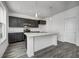 A kitchen with dark cabinets, marble countertops, stainless steel appliances, and modern pendant lighting at 1952 White Oak Ln, Shelbyville, IN 46176