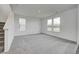 Open living room with carpet floors, bright windows, and white walls at 1952 White Oak Ln, Shelbyville, IN 46176
