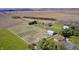 Beautiful aerial view of the property including fenced pastures, a pond, outbuildings, and a well-maintained home at 2009 W 250 N, Lebanon, IN 46052