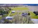 Expansive aerial view showcases the property, fenced pastures, barn, and a long driveway to a charming home at 2009 W 250 N, Lebanon, IN 46052