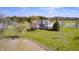 Home featuring a pond, a deck, established trees, and expansive green space, perfect for outdoor enjoyment at 2009 W 250 N, Lebanon, IN 46052