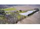 Scenic aerial perspective of the home, a tranquil pond, and surrounding acreage, offering privacy and natural beauty at 2009 W 250 N, Lebanon, IN 46052