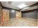 Spacious basement area featuring laminate wood flooring, two doors, and neutral paint at 2009 W 250 N, Lebanon, IN 46052