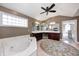Bathroom with a soaking tub, tile floors, windows, and a ceiling fan at 2009 W 250 N, Lebanon, IN 46052
