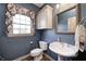 Cozy bathroom featuring a pedestal sink, classic fixtures, and charming window treatment at 2009 W 250 N, Lebanon, IN 46052