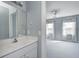 Bathroom with sink and large mirror opens to the bedroom with two windows and scenic views at 2009 W 250 N, Lebanon, IN 46052