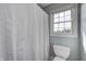 Bathroom features a toilet next to a window and a striped shower curtain at 2009 W 250 N, Lebanon, IN 46052