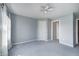 Spacious bedroom with neutral paint and carpet, a ceiling fan and two doors at 2009 W 250 N, Lebanon, IN 46052