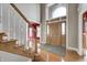 Grand foyer featuring a soaring ceiling, wood floors, a staircase, and a front door with decorative windows at 2009 W 250 N, Lebanon, IN 46052