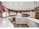 A spacious kitchen features bright countertops, a central island, and stainless steel appliances at 2009 W 250 N, Lebanon, IN 46052