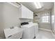 Functional laundry room features a sink, washer, dryer, and cabinet space at 2009 W 250 N, Lebanon, IN 46052