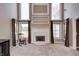Living room boasts a fireplace, elegant windows, a rocking chair, and neutral carpeting at 2009 W 250 N, Lebanon, IN 46052
