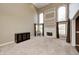 Bright living room with high ceilings, neutral carpeting, a fireplace, and large windows with elegant draperies at 2009 W 250 N, Lebanon, IN 46052