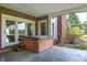 Enjoy relaxation in the covered patio's wooden hot tub, easily accessible from the house at 2009 W 250 N, Lebanon, IN 46052