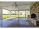 Covered patio with a stone fireplace providing outdoor space for relaxing and entertaining overlooking the yard at 2009 W 250 N, Lebanon, IN 46052