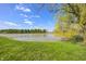 Scenic view of the property's private pond surrounded by mature trees and lush greenery at 2009 W 250 N, Lebanon, IN 46052