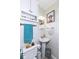A small bathroom featuring a toilet, pedestal sink and decorative artwork to add a splash of personality at 202 Rainbow Blvd, Indianapolis, IN 46234