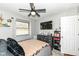 Bedroom with dark wood floors, neutral walls, a window, and a large flat-screen television at 202 Rainbow Blvd, Indianapolis, IN 46234