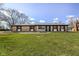 Charming brick home with a well-manicured lawn and vibrant green grass under a bright sky at 202 Rainbow Blvd, Indianapolis, IN 46234