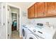 Laundry room with a washer and dryer set and door leading into the bathroom and bedroom at 202 Rainbow Blvd, Indianapolis, IN 46234