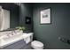 Elegant powder room with gray vanity, marble countertop, modern fixtures, and stylish wall decor at 2051 Columbia Ave, Indianapolis, IN 46202