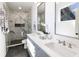 Modern bathroom features a large shower, double vanity, and stylish lighting fixtures at 2051 Columbia Ave, Indianapolis, IN 46202