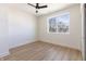 Light-filled bedroom with ceiling fan, wood-look floors, and a large window offering natural light at 2051 Columbia Ave, Indianapolis, IN 46202