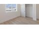Bedroom with wood-look floors, closet, and a window showcasing outside view at 2051 Columbia Ave, Indianapolis, IN 46202