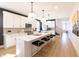 Modern open kitchen with white cabinetry, quartz countertops, and an island with seating at 2051 Columbia Ave, Indianapolis, IN 46202