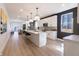 Modern open kitchen with white cabinetry, quartz countertops, and an island with seating at 2051 Columbia Ave, Indianapolis, IN 46202