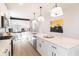 Modern white kitchen with stainless steel appliances and bright lighting, featuring a spacious island at 2051 Columbia Ave, Indianapolis, IN 46202