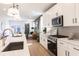 Bright kitchen with quartz counters, stainless appliances, and a view to the living room at 2051 Columbia Ave, Indianapolis, IN 46202