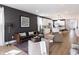 Stylish living room with modern furniture, dark accent wall, and open layout leading to the kitchen at 2051 Columbia Ave, Indianapolis, IN 46202