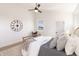 Cozy bedroom with a clock on the wall, comfortable bed, and ceiling fan at 2051 Columbia Ave, Indianapolis, IN 46202