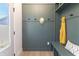 Bright mudroom featuring beadboard walls, convenient hooks, bench, and a view to the outdoors at 2051 Columbia Ave, Indianapolis, IN 46202