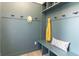 Stylish mudroom with teal beadboard, hooks, bench seating, and built-in shelving for organization at 2051 Columbia Ave, Indianapolis, IN 46202