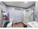 Functional bathroom with a corner shower, toilet, sink, and wood-look flooring at 215 S Warman Ave, Indianapolis, IN 46222