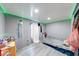 This bedroom offers neutral walls, wood-look flooring, and green led accent lighting at 215 S Warman Ave, Indianapolis, IN 46222