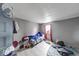 Modest bedroom with fair natural light and essential furnishings at 215 S Warman Ave, Indianapolis, IN 46222
