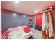 Cozy bedroom featuring a closet, wood-look floors and red LED accent lighting at 215 S Warman Ave, Indianapolis, IN 46222