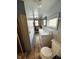 Long bathroom with a white sink and wood framed windows at 2233 W 28Th St, Anderson, IN 46016