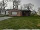 Charming single-story home with lawn and gravel driveway at 2233 W 28Th St, Anderson, IN 46016