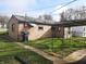 Back exterior of home featuring a well-kept lawn and shed at 2233 W 28Th St, Anderson, IN 46016