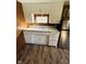 Kitchen with white cabinets, laminate floors, and stainless refrigerator at 2233 W 28Th St, Anderson, IN 46016