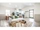 Bright open-concept living room with soft seating, luxury floors, and dining area at 2361 Southeastern Ave, Indianapolis, IN 46201
