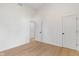 Bright bedroom with wood-look floors and a door to the hallway at 2362 English Ave, Indianapolis, IN 46201