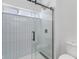 Modern glass shower with white subway tile and updated fixtures at 2362 English Ave, Indianapolis, IN 46201