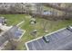 Aerial view of a well-maintained parking lot, green spaces, and a gazebo near townhouses with a tranquil pond at 256 Strand Ln # Apt C, Avon, IN 46123