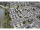 Aerial view of residential townhouses, manicured lawns, a scenic pond, and convenient parking areas in a peaceful setting at 256 Strand Ln # Apt C, Avon, IN 46123